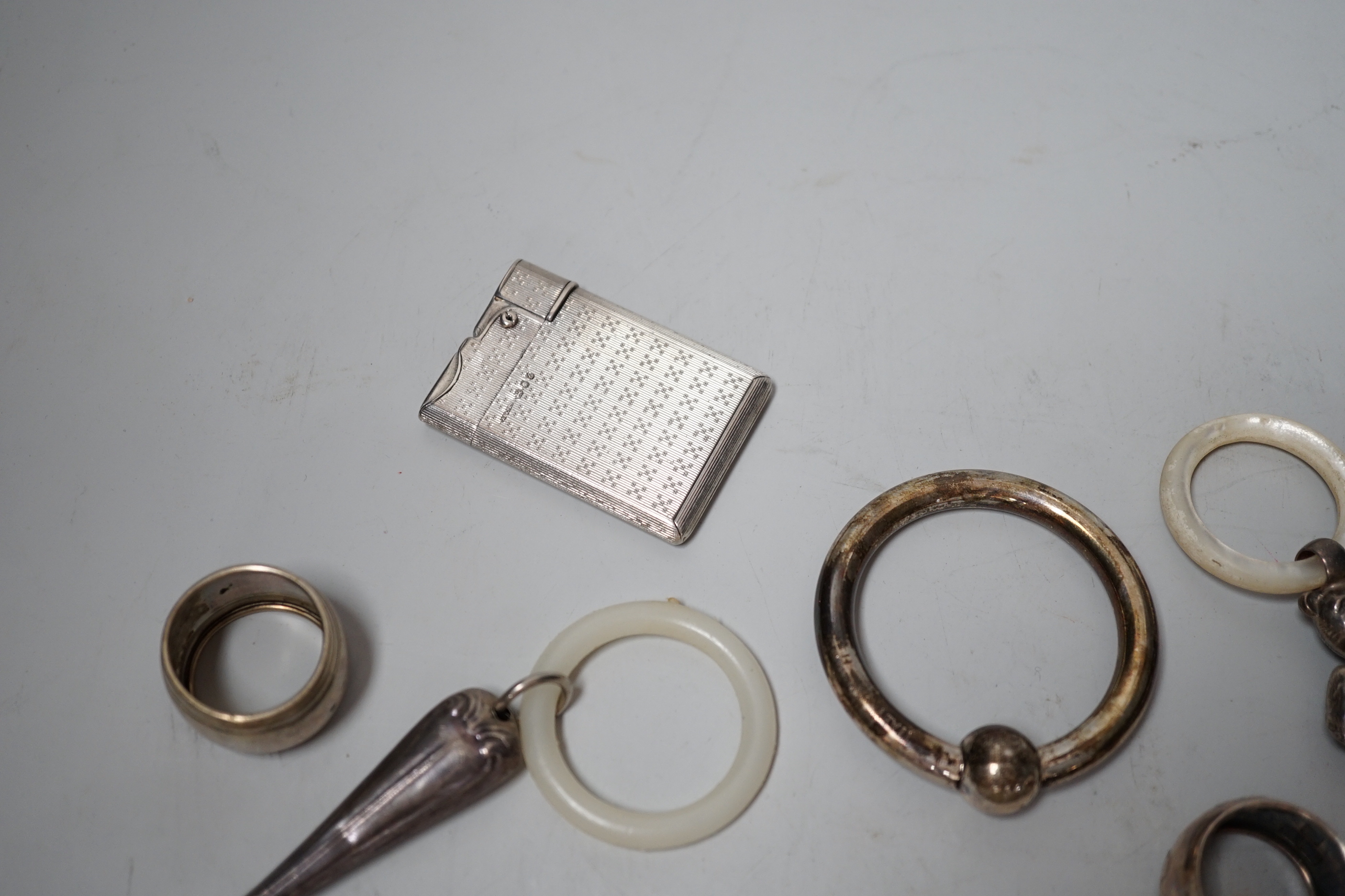 Sundry small silver and other items including teethers, rattles, Asprey & Co silver mounted lighter, etc.